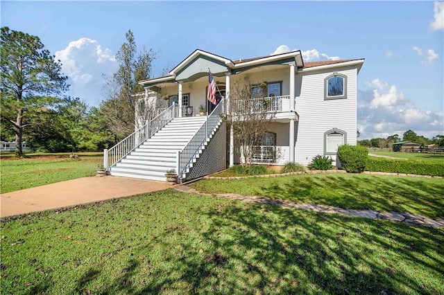 view of front of home featuring covered porch and a front yard