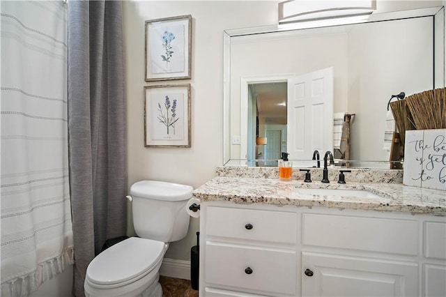 bathroom featuring vanity, toilet, and walk in shower