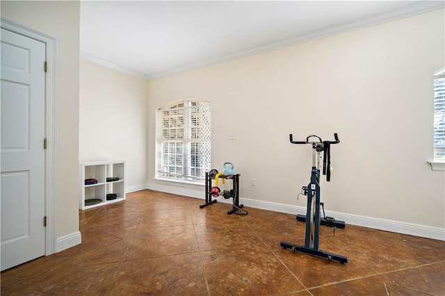 workout room featuring crown molding and dark tile patterned flooring