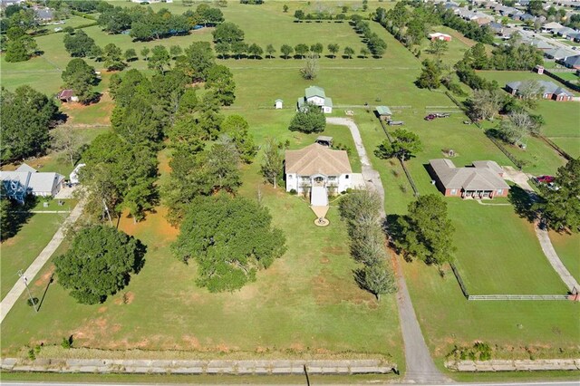 birds eye view of property with a rural view