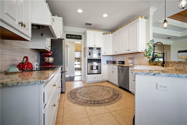 kitchen featuring white cabinets, pendant lighting, stainless steel appliances, and sink