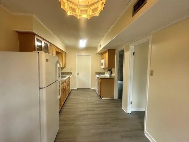 kitchen with crown molding, white appliances, and light hardwood / wood-style flooring