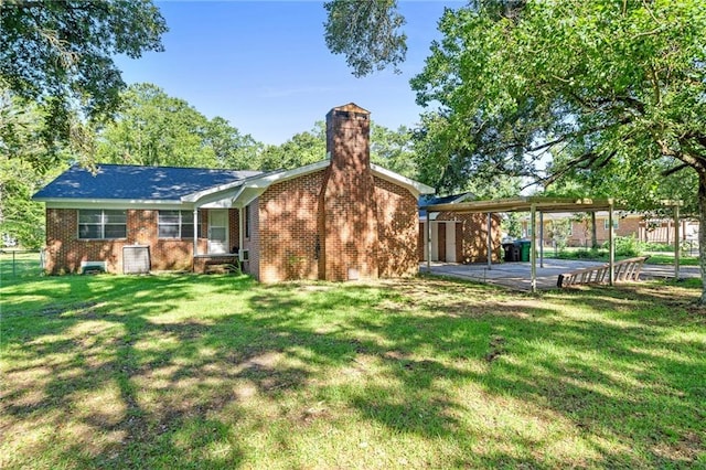 back of property with a yard and a patio area