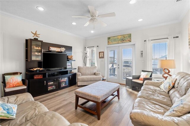 living area with recessed lighting, light wood-style floors, ornamental molding, and ceiling fan