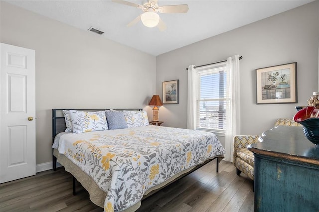 bedroom featuring baseboards, a ceiling fan, visible vents, and dark wood-style flooring