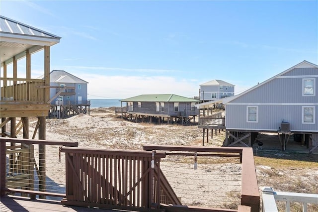 view of yard featuring cooling unit and a deck with water view