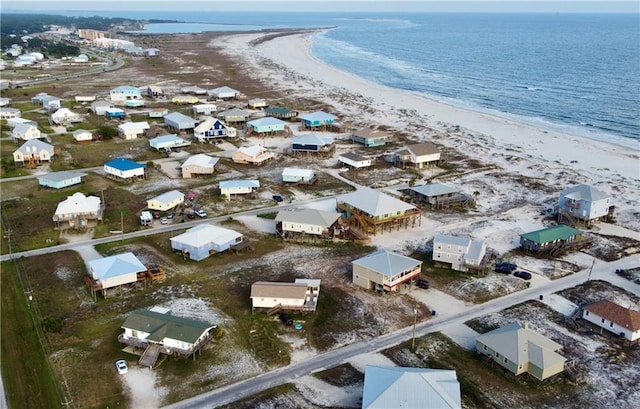 birds eye view of property with a beach view and a water view