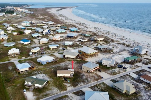birds eye view of property featuring a beach view and a water view