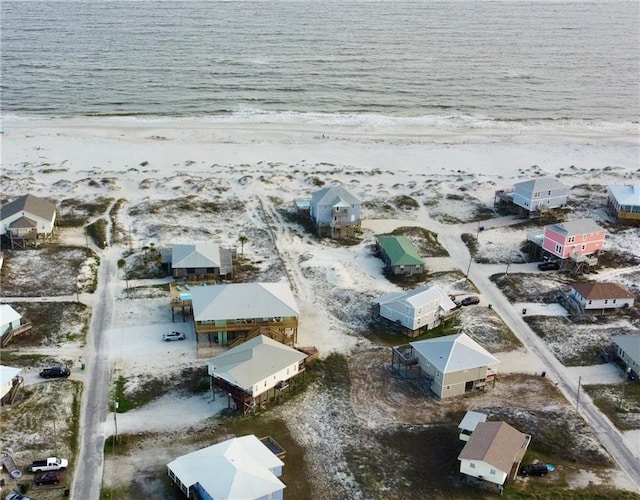 bird's eye view featuring a view of the beach and a water view