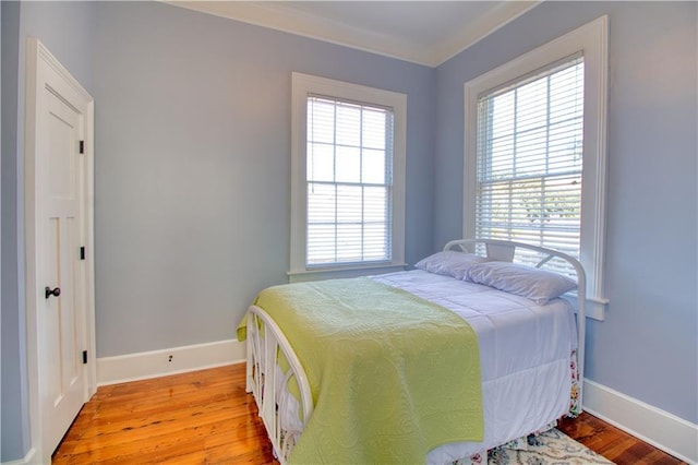 211 Cedar St, Mobile, AL 36602 - bedroom with baseboards and light wood-style flooring