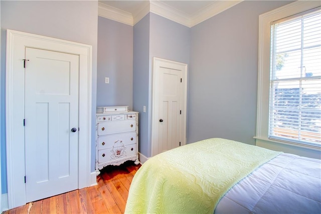 211 Cedar St, Mobile, AL 36602 - bedroom with light wood finished floors, multiple windows, and crown molding