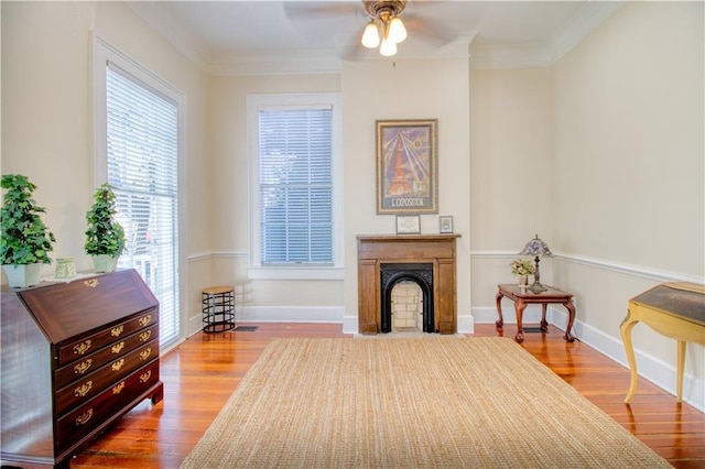 211 Cedar St, Mobile, AL 36602 - sitting room with ceiling fan, wood finished floors, a fireplace, and crown molding