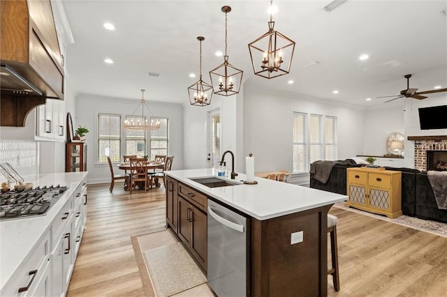 3699 Elysian Fields Dr, Saraland, AL 36571 - kitchen with stainless steel appliances, a sink, ornamental molding, a chandelier, and light countertops