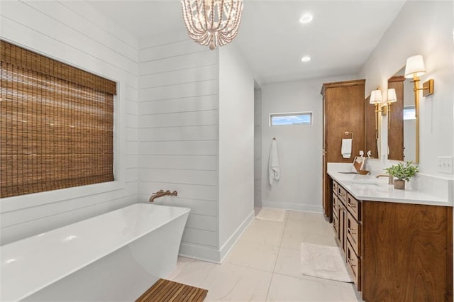 3699 Elysian Fields Dr, Saraland, AL 36571 - bathroom featuring a freestanding bath, baseboards, a chandelier, vanity, and recessed lighting