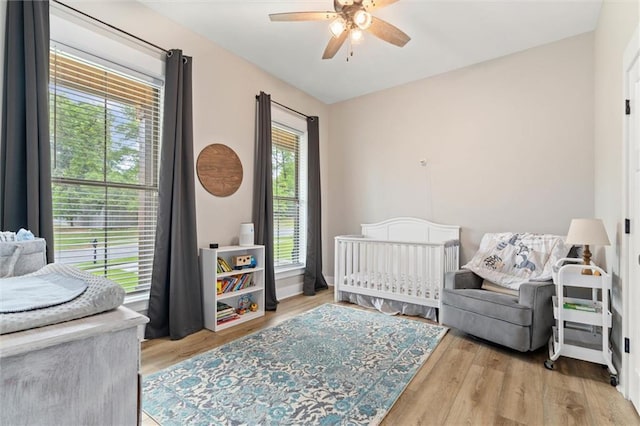 3699 Elysian Fields Dr, Saraland, AL 36571 - bedroom featuring wood finished floors, a crib, and ceiling fan