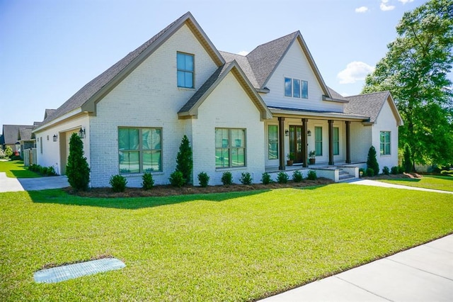 3699 Elysian Fields Dr, Saraland, AL 36571 - view of front of property with covered porch, brick siding, a front yard, driveway, and a garage