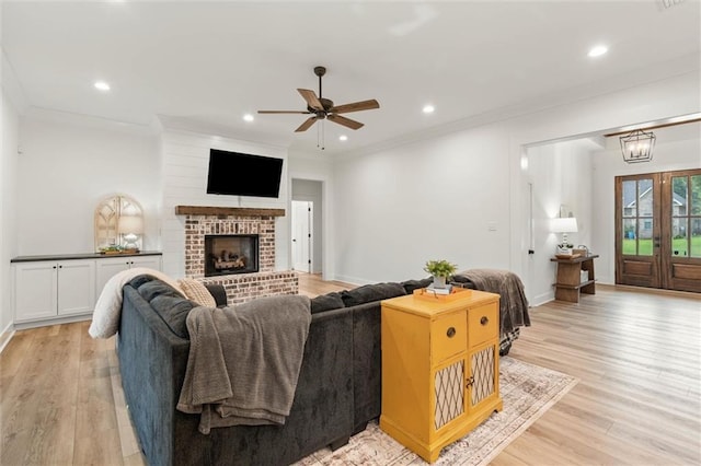 3699 Elysian Fields Dr, Saraland, AL 36571 - living room with a ceiling fan, light wood-type flooring, ornamental molding, recessed lighting, and a fireplace