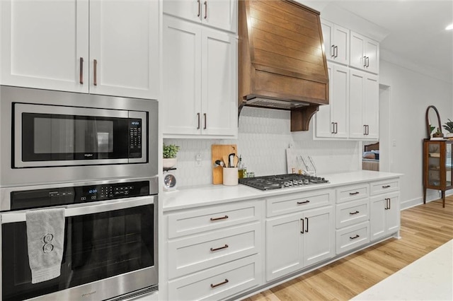 3699 Elysian Fields Dr, Saraland, AL 36571 - kitchen featuring custom range hood, appliances with stainless steel finishes, and light countertops