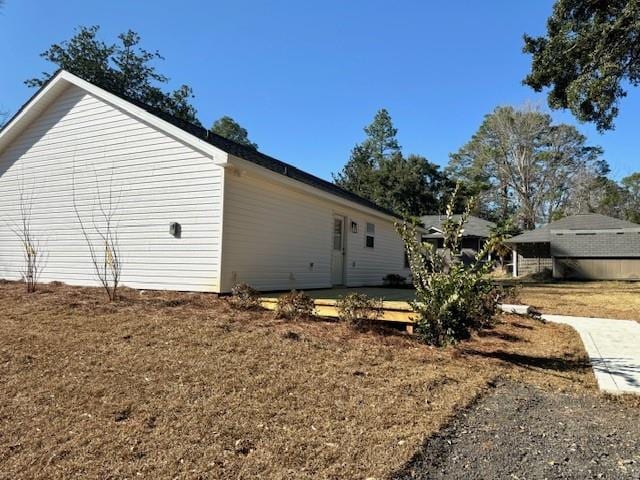 view of side of home featuring a lawn