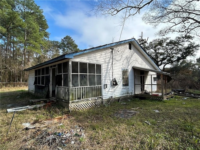 view of side of property with a sunroom