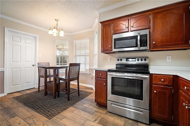 kitchen with pendant lighting, light hardwood / wood-style flooring, ornamental molding, a textured ceiling, and appliances with stainless steel finishes