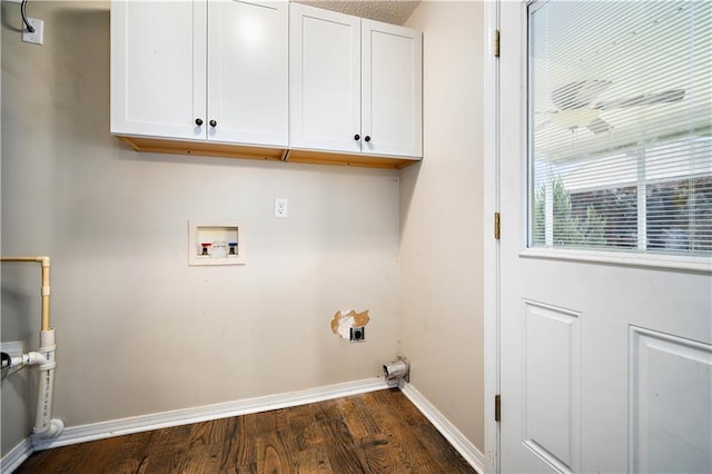 laundry room featuring washer hookup, cabinets, and dark wood-type flooring