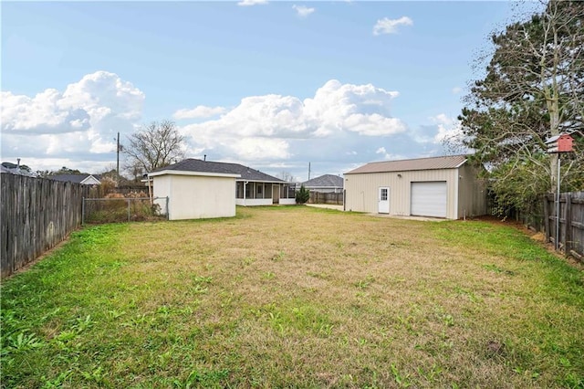 view of yard featuring an outdoor structure and a garage