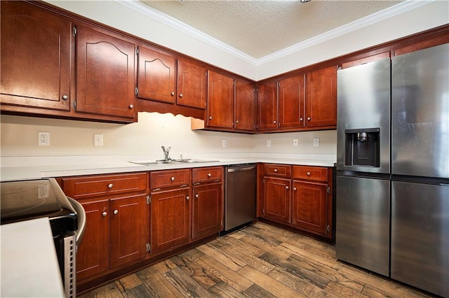 kitchen with sink, crown molding, dark hardwood / wood-style floors, a textured ceiling, and appliances with stainless steel finishes