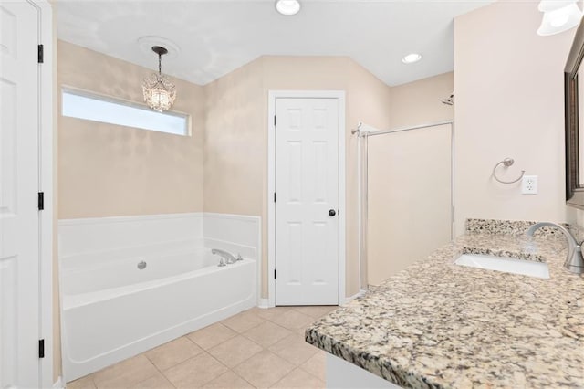 full bath featuring vanity, a bath, a stall shower, tile patterned flooring, and a notable chandelier