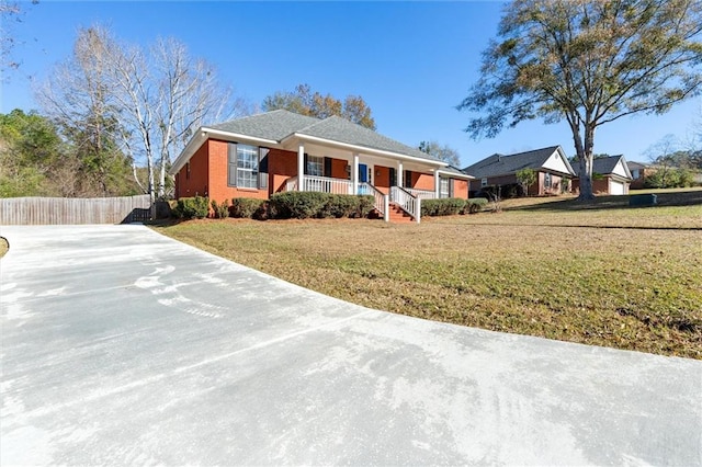 ranch-style house with covered porch and a front yard