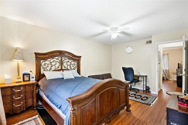 bedroom with ceiling fan and dark hardwood / wood-style floors