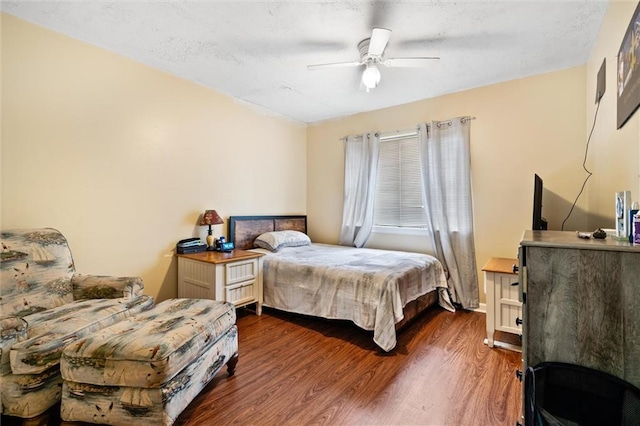 bedroom with ceiling fan and dark hardwood / wood-style floors