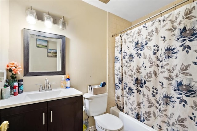 full bathroom featuring vanity, shower / tub combo with curtain, and toilet