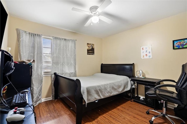 bedroom with ceiling fan and dark wood-type flooring