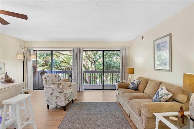 204 Golf Ter Unit 204, Daphne, AL 36526 - living area featuring ceiling fan, plenty of natural light, wood finished floors, and a textured ceiling