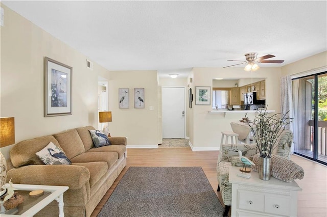 204 Golf Ter Unit 204, Daphne, AL 36526 - living area with light wood-style flooring, baseboards, ceiling fan, and a textured ceiling