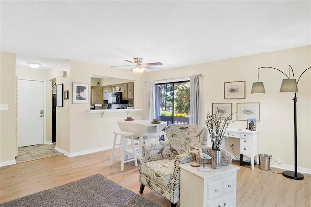 204 Golf Ter Unit 204, Daphne, AL 36526 - living room featuring light wood-type flooring, ceiling fan, and baseboards