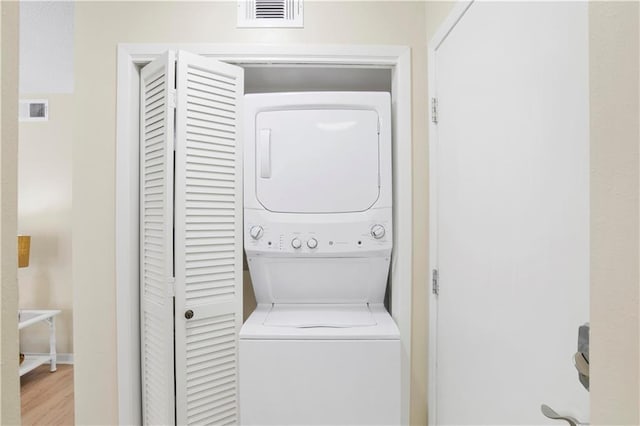 204 Golf Ter Unit 204, Daphne, AL 36526 - clothes washing area featuring stacked washing machine and dryer and light wood-style flooring