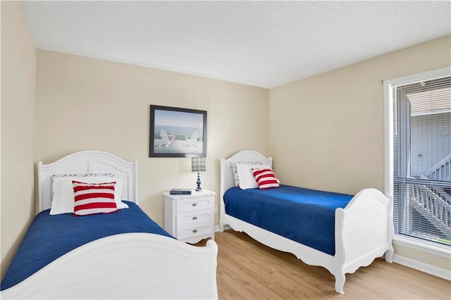 204 Golf Ter Unit 204, Daphne, AL 36526 - bedroom featuring wood finished floors, baseboards, and a textured ceiling