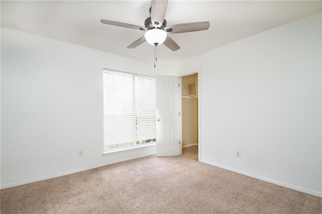 unfurnished bedroom with baseboards, multiple windows, and light carpet