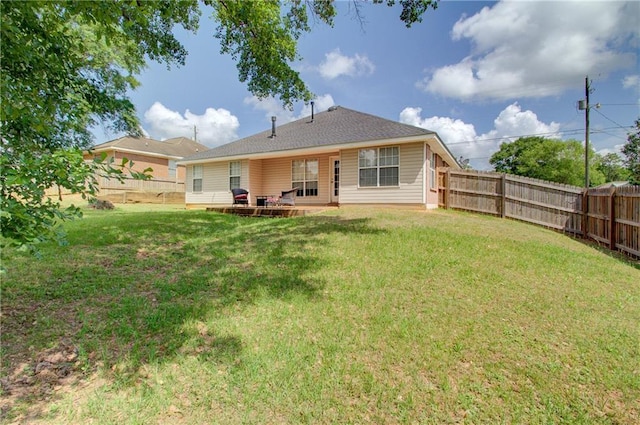 rear view of house with a lawn, a patio, and a fenced backyard