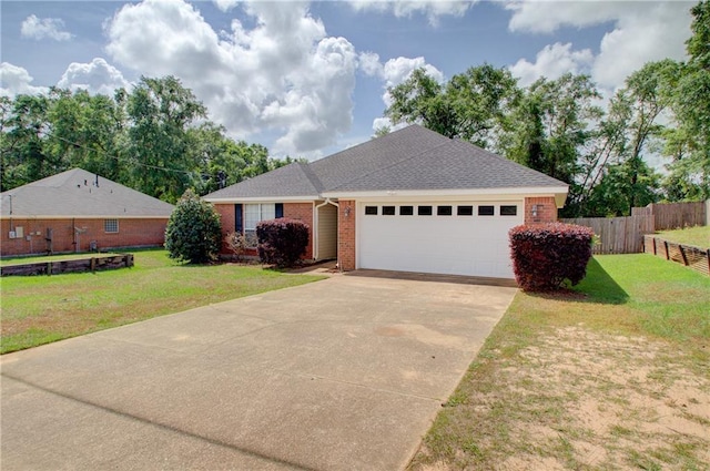 single story home with a garage, a front lawn, fence, brick siding, and concrete driveway