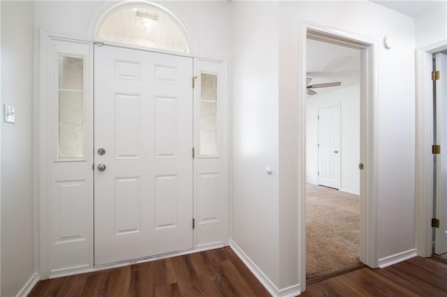 entrance foyer with baseboards, a ceiling fan, and dark wood finished floors