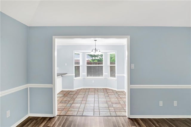 3011 Olde Gate Rd, Mobile, AL 36695 - empty room featuring a chandelier, wood finished floors, and vaulted ceiling