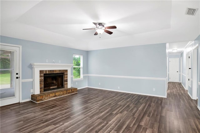 3011 Olde Gate Rd, Mobile, AL 36695 - unfurnished living room with a tray ceiling, dark wood-type flooring, ceiling fan, and a fireplace