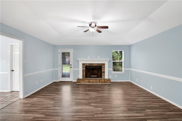 3011 Olde Gate Rd, Mobile, AL 36695 - unfurnished living room with a ceiling fan, dark wood-style floors, a fireplace, and a raised ceiling