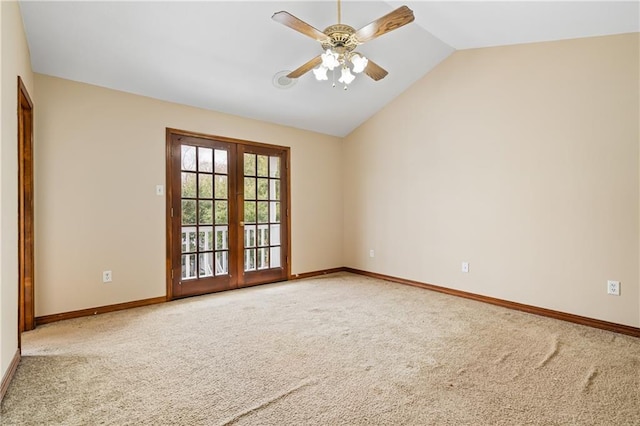 carpeted empty room with baseboards, vaulted ceiling, a ceiling fan, and french doors