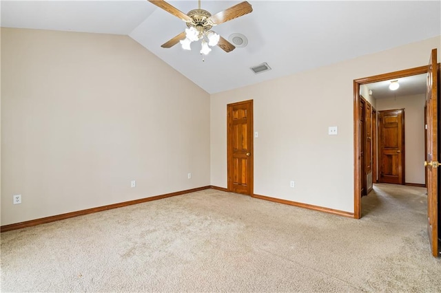 unfurnished room featuring vaulted ceiling, baseboards, visible vents, and light colored carpet