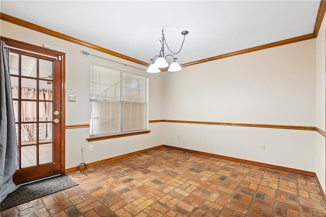 interior space featuring brick floor, a chandelier, ornamental molding, and baseboards