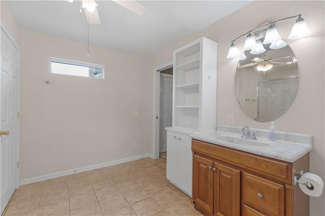 bathroom featuring tile patterned flooring, vanity, baseboards, and a ceiling fan